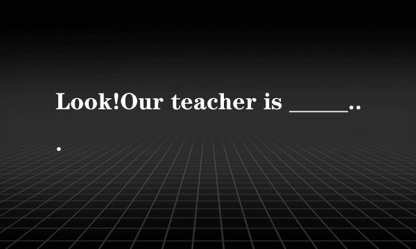 Look!Our teacher is ______ the exam papers>